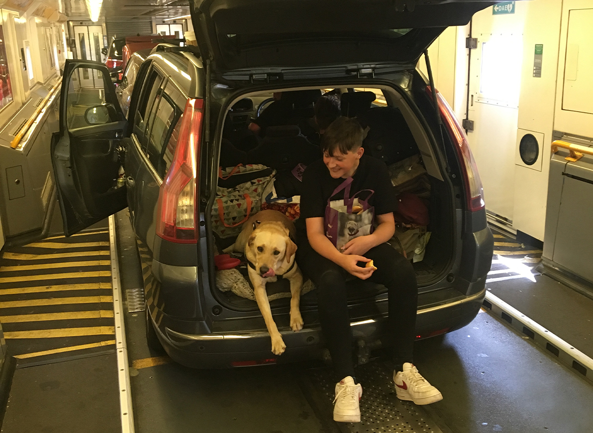 Boy and dog, in the back of the car on board a Eurotunnel shuttle